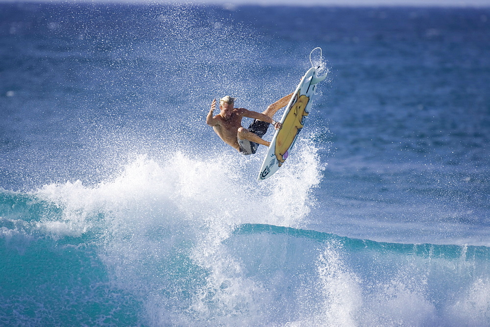 surfer performing an ariel manoeuvre, Hawaii