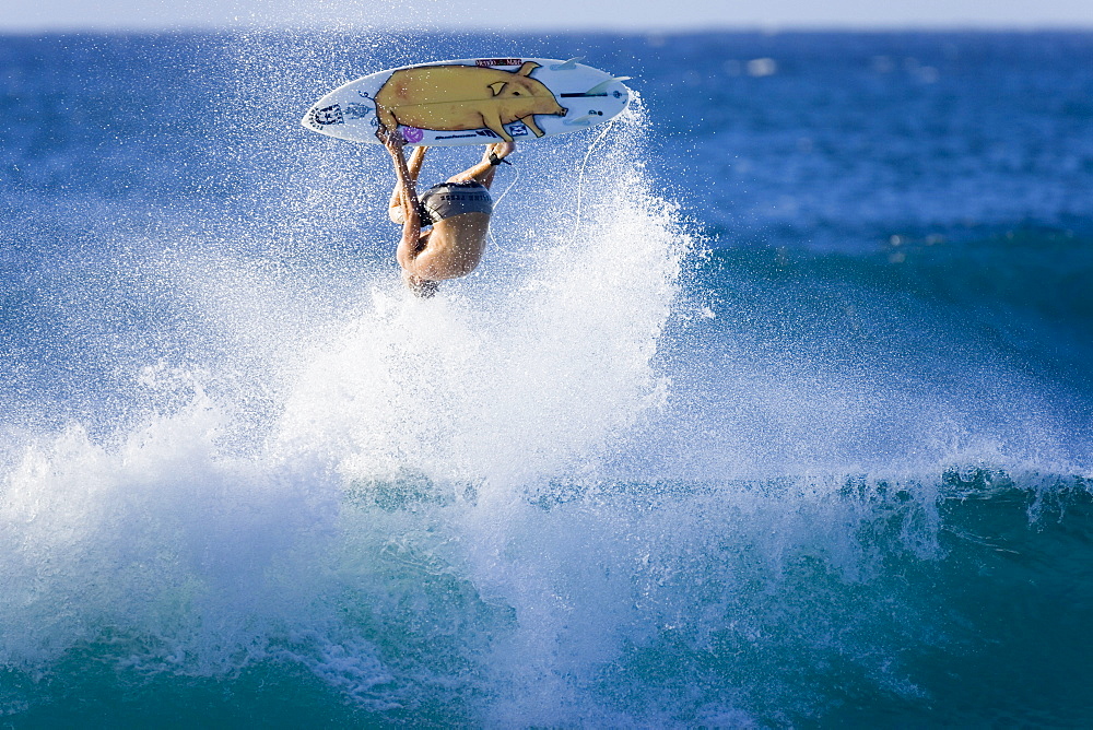 surfer performing an ariel manoeuvre, Hawaii