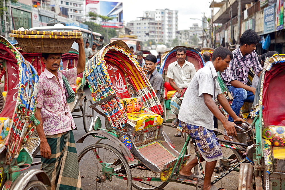 Dhaka,  Bangladesh - July 2011: Street traffic in Dhaka.  With over 400, 000 rickshaws running the streets on Dhaka every day the Bangladeshi capital has been described as the "Rickshaw capital of the world.