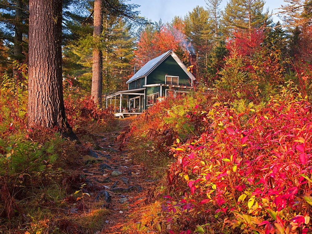 Colorful fall foliage defines the pathway from Richardson Lake to this historic hunting and fishing camp in western Maine.  Ben Pearson,  the fourth generation in his family to own the camp,  is carefully restoring the main building,  three boat houses an