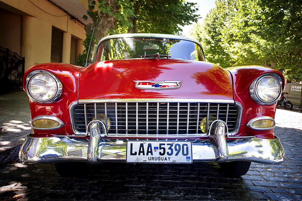 A red classic car parked in the street at Colonia del Sacramento, Uruguay.