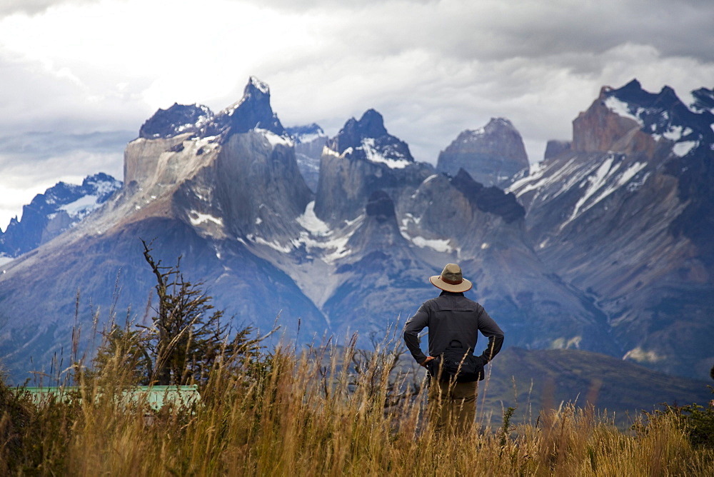 TORRES DEL PAINE NATIONAL PARK, PATAGONIA, CHILE. Hikers enjoy one of the best national parks in South America on a sunny day. With steep peaks full of hanging glaciers and glacial silt-filled lakes, Torres del Paine is one of the greatest attractions on Earth.