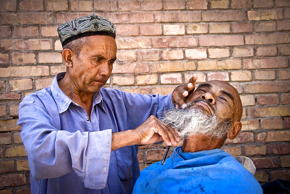 Street barber, Kashgar, Xinjiang Province, China.