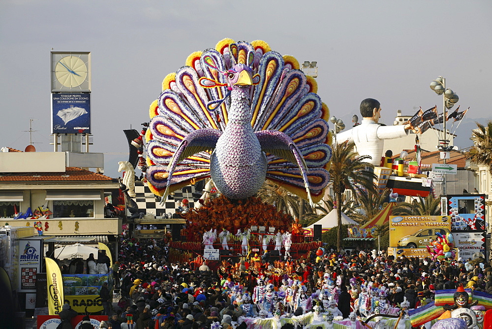 Masks and caricatures of politicians singing and dancing in the streets and enormous paper mache floats, surrounded by thousands of people, in the great celebration of the Carnival of Viareggio.