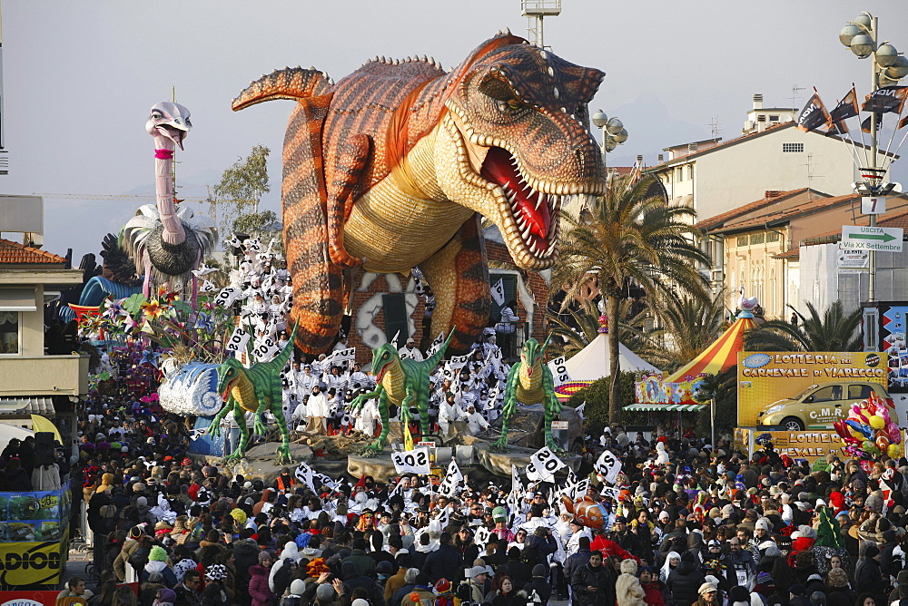 Masks and caricatures of politicians singing and dancing in the streets and enormous paper mache floats, surrounded by thousands of people, in the great celebration of the Carnival of Viareggio.