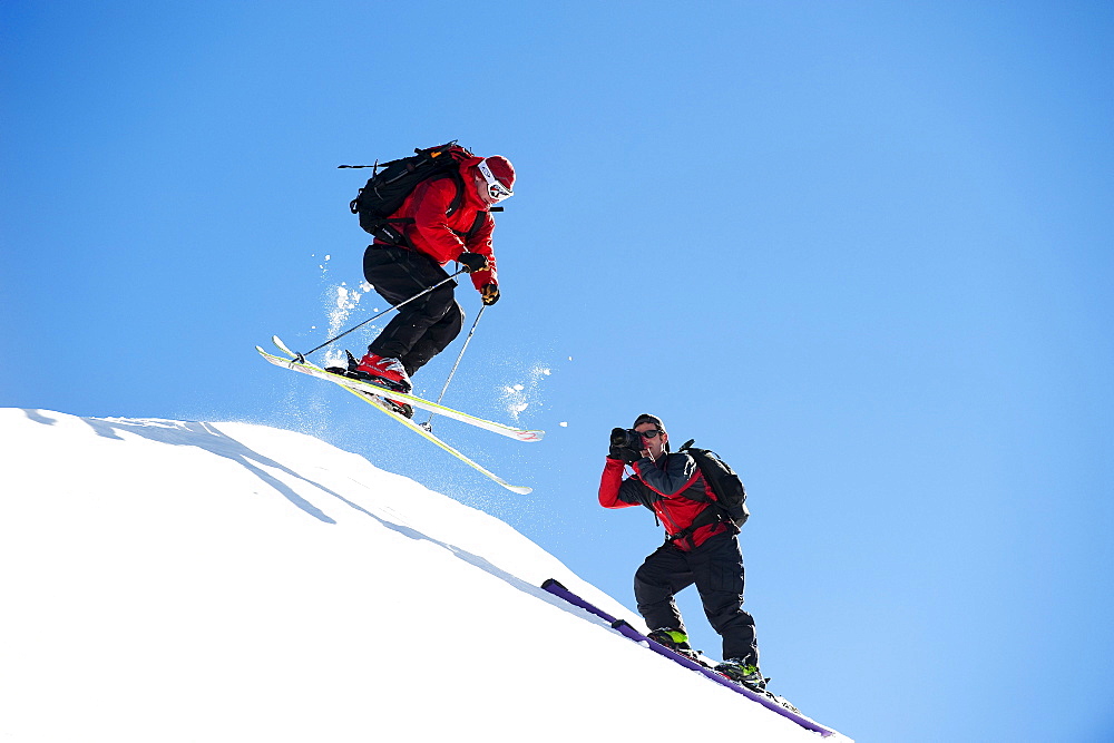 A photographer photographs a skier.