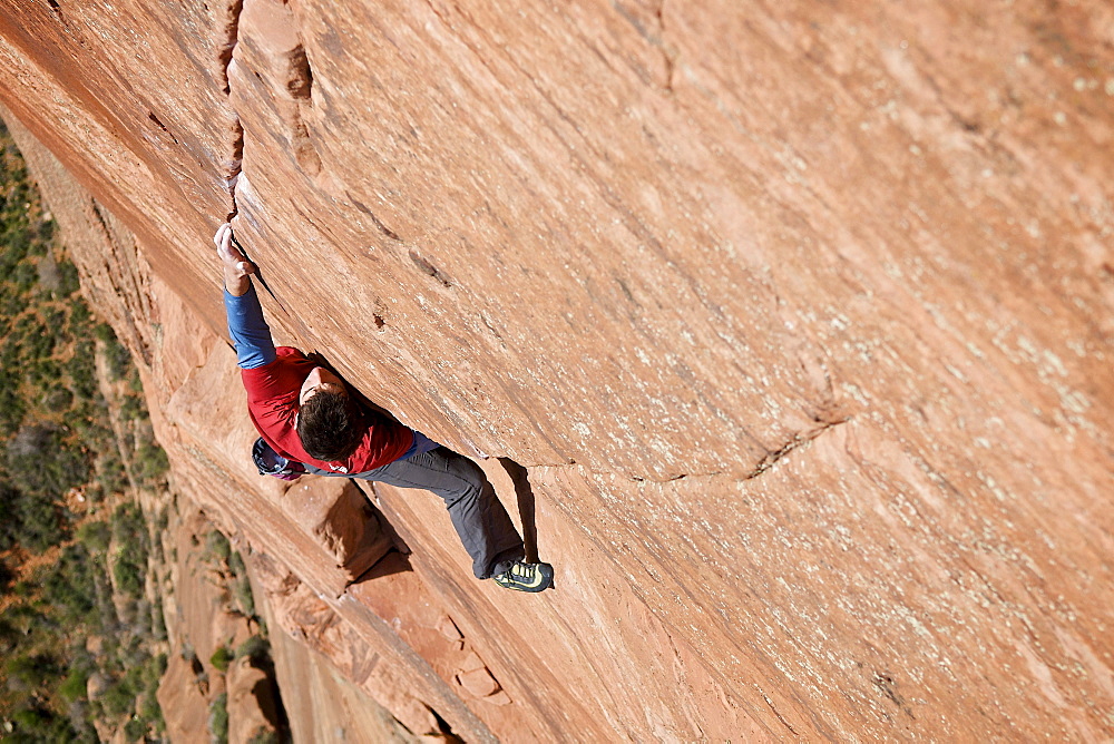 A man rock climbing in Zion National Park, UT.