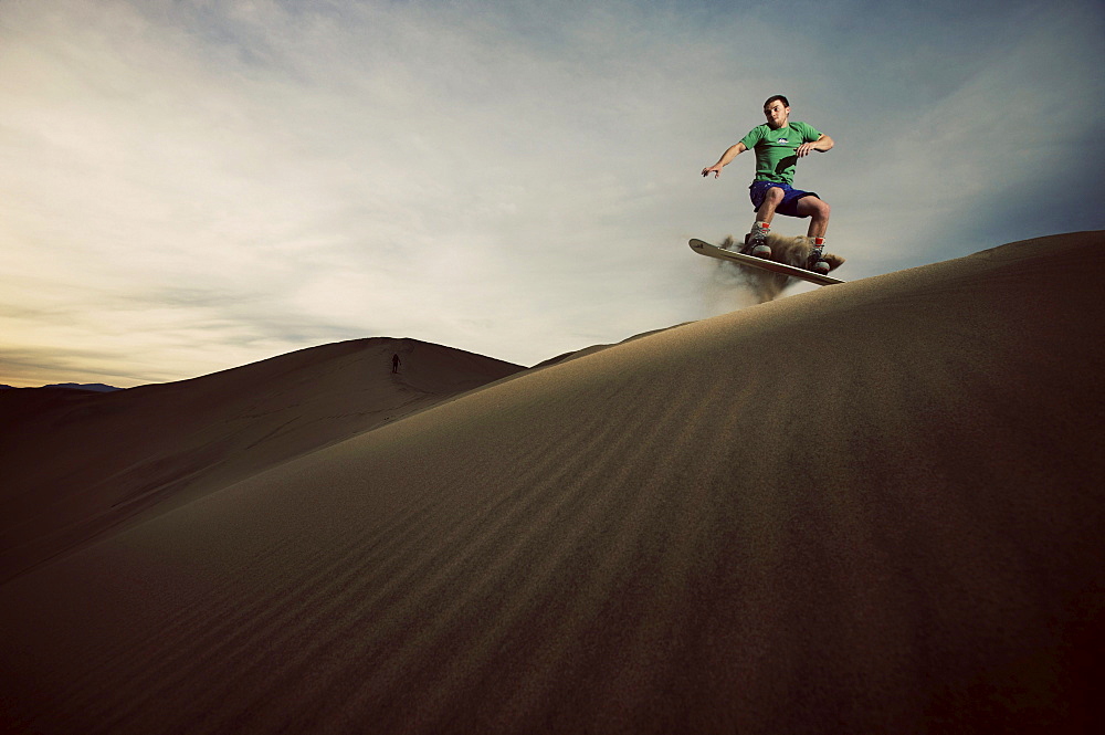 Lone sand boarder heads down one of the dunes.