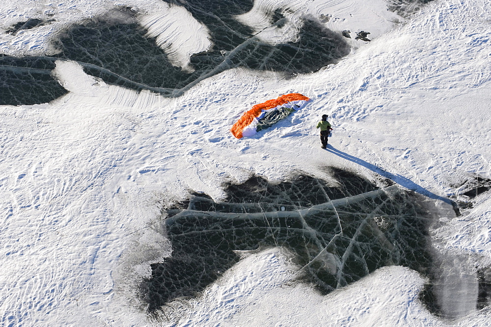 A snowkiter setting up their snowkite on the frozen Missouri River in North Dakota.