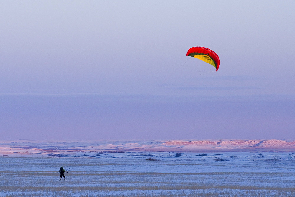 Snowkiting in North Dakota with the last light of day during the 2XtM expedition.