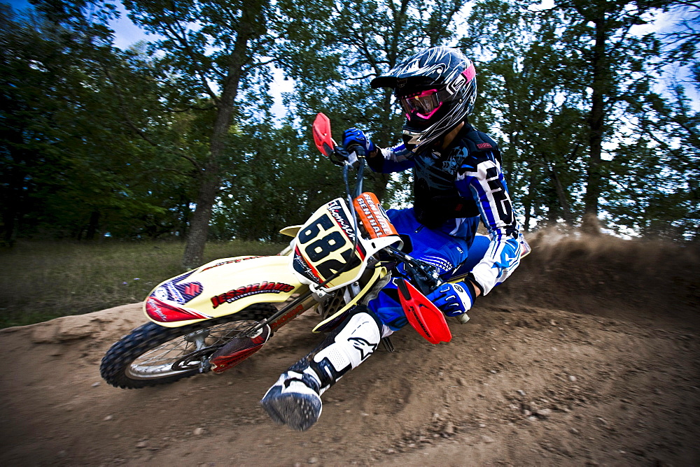 Motocross biker leans into a sharp turn in Brainerd, Minnesota.