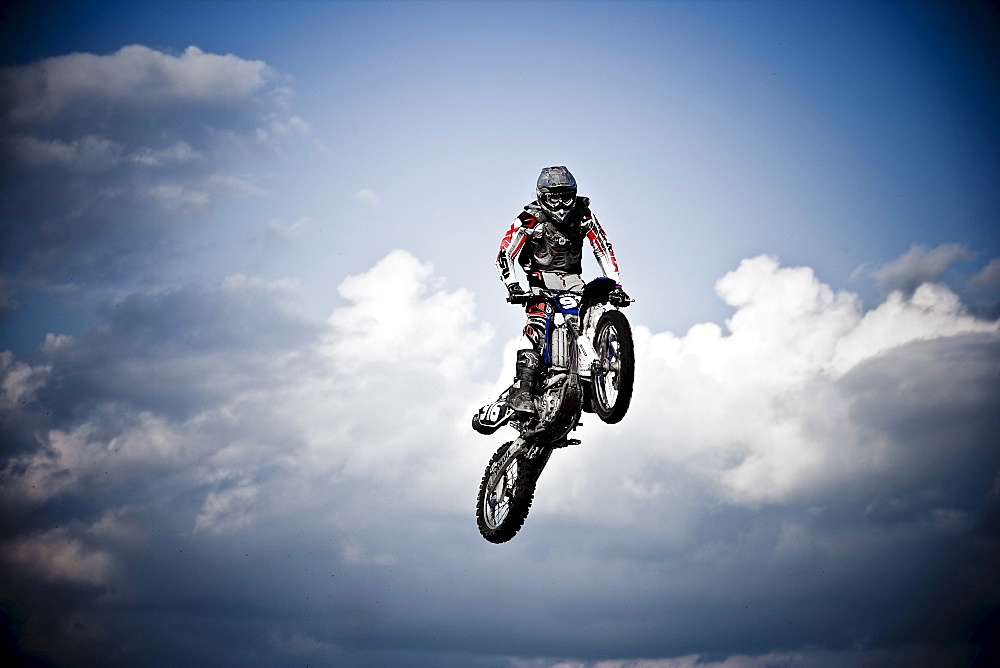 A motocross biker sails through the clouds in Brainerd, Minnesota.