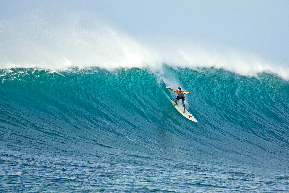 A young man surfing at Sunset Beach, north shore, Oahu, Hawaii.