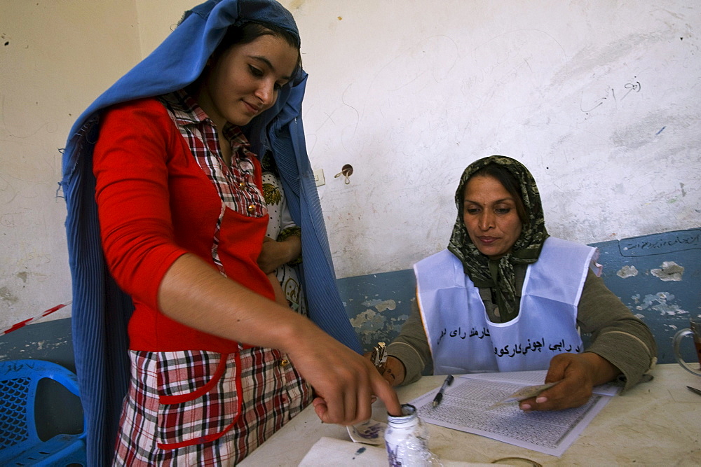 A young woman prepares to vote for presidential and provincial candidates in national elections, Sultan Razia Girls High School, Mazar-i Sharif, Afghanistan on August 20, 2009.