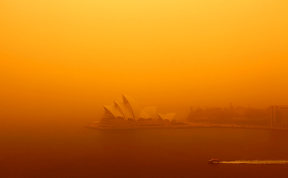 Apocalyptic vision of Sydney shrouded in red dust blown in by winds from the deserts of the outback.