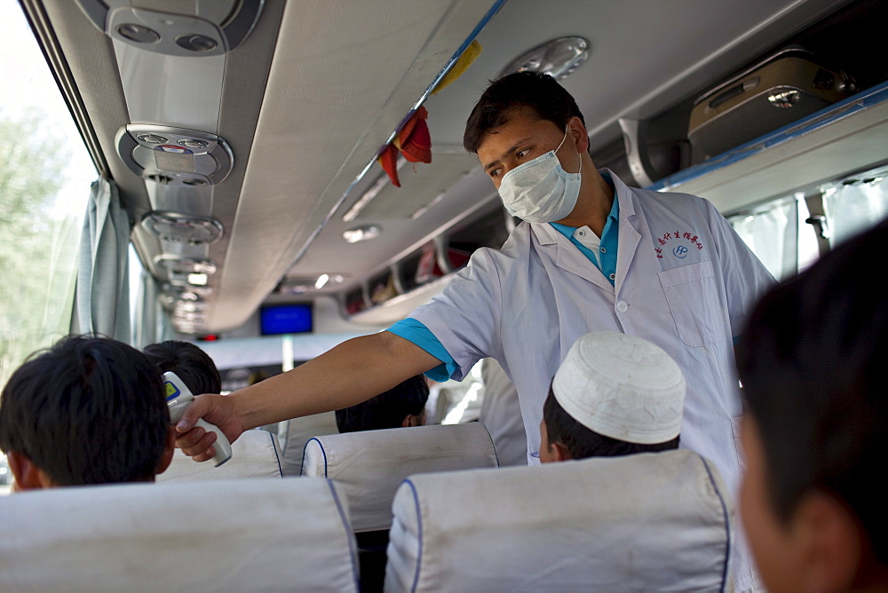 Testing for the H1N1 virus on a bus near Khotan, Xinjiang, China.