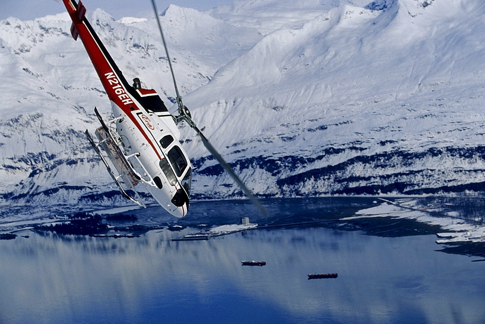 Helicopter heading back to base after dropping off skiers, Valdez, Alaska.