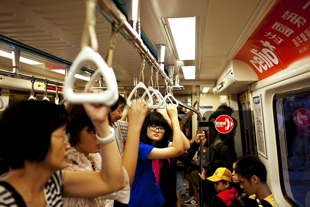 A teenage girl rides the MRT in Taipei, Taiwan, October 23, 2010.