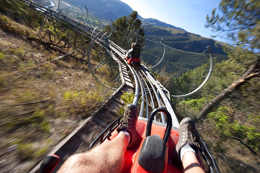 Two men ride the Alpine Coaster above Glenwood Springs at Glenwood Caverns Adventure Park, CO.