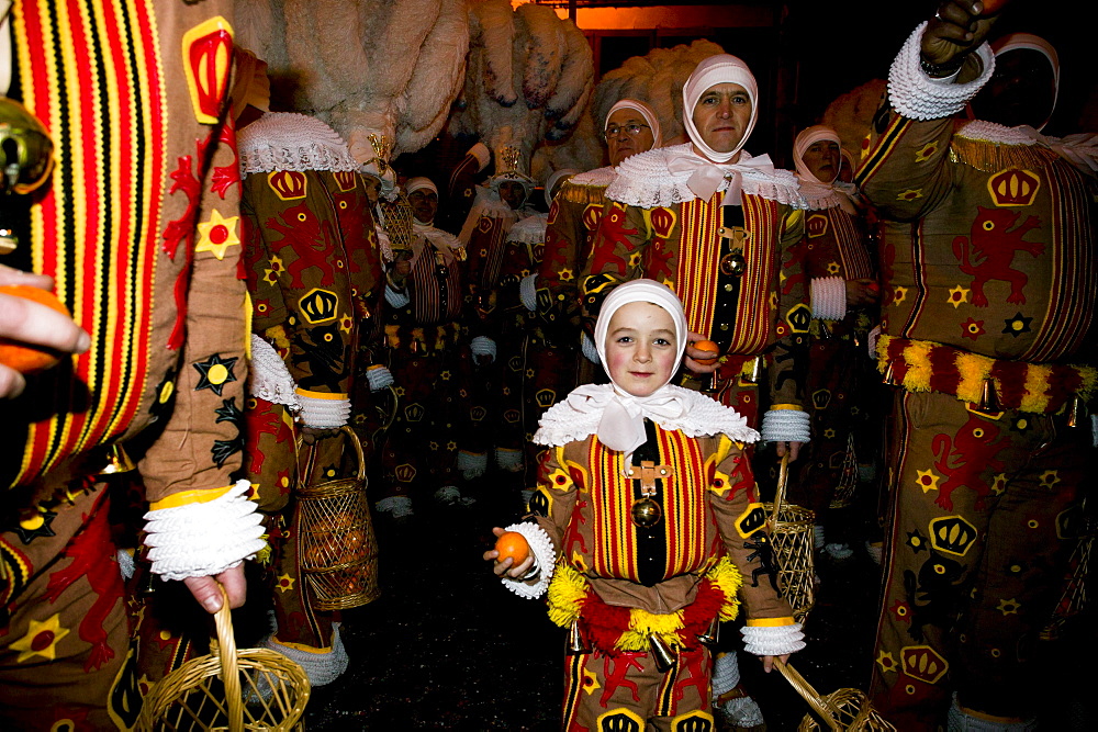 A tiny Gilles with his last orange at the Carnival in Binche, Belgium.