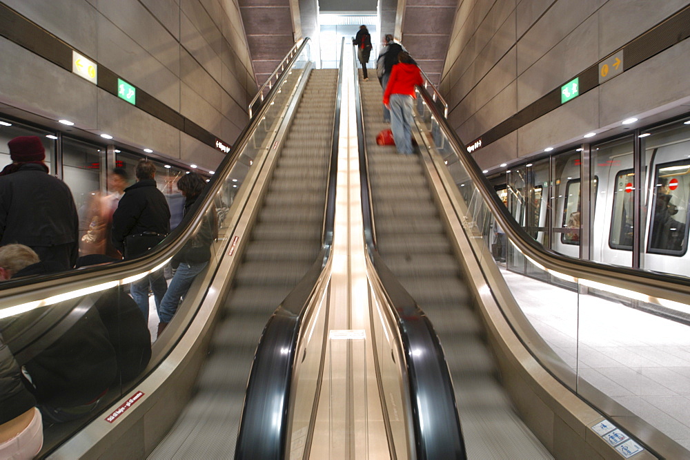 Commuters ride the escalator and board subway trains in Copenhagen, Denmark. Scandinavia.