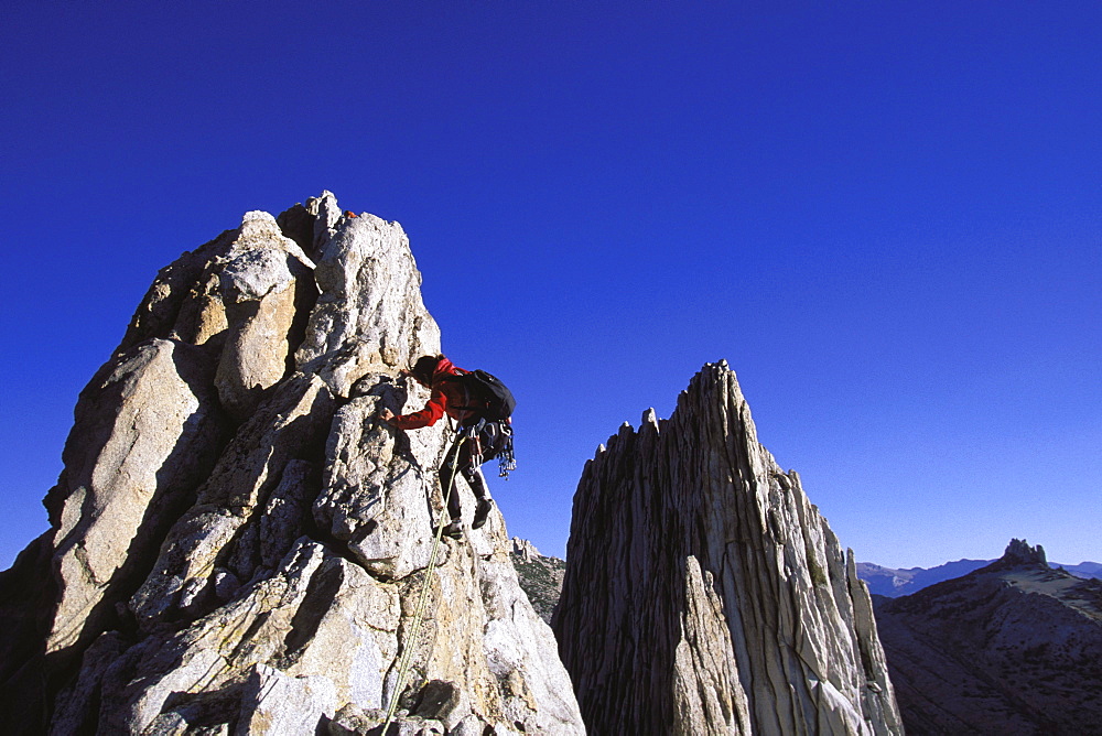 Roberta Nunes climbing Mathes Crest above Tuolumne Meadows in Yosemite National Park, California.