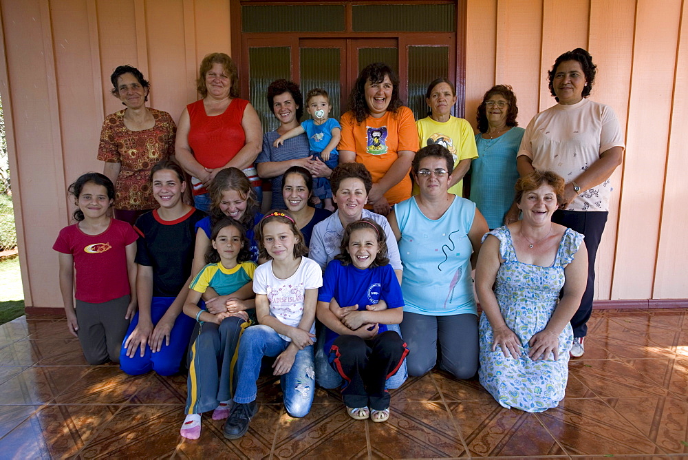 Members of a cooperative of local farmers who grow medicinal herbs and other organic products in and around the small community of Turvo, central Parana state, Brazil gather for a communial lunch.