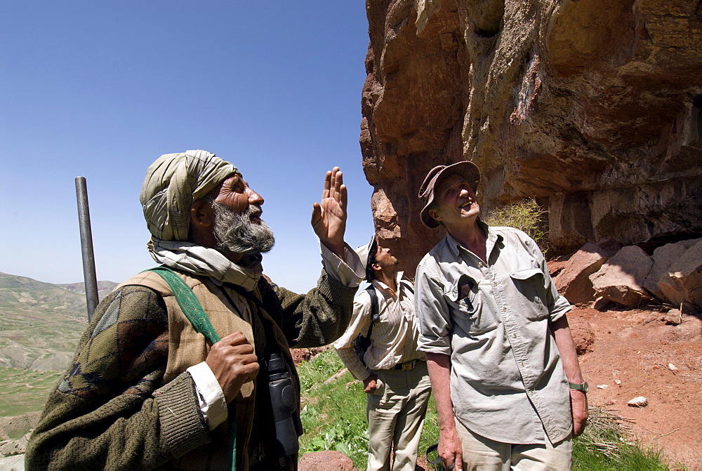 A local hunter, Abdul Rahim, discusses wild animals and their habitat with a wildlife biologist, Dr. George Schaller and his assistant, who are conducting a wildlife survey, in the Band-e Baba range, Herat Province, Afghanistan