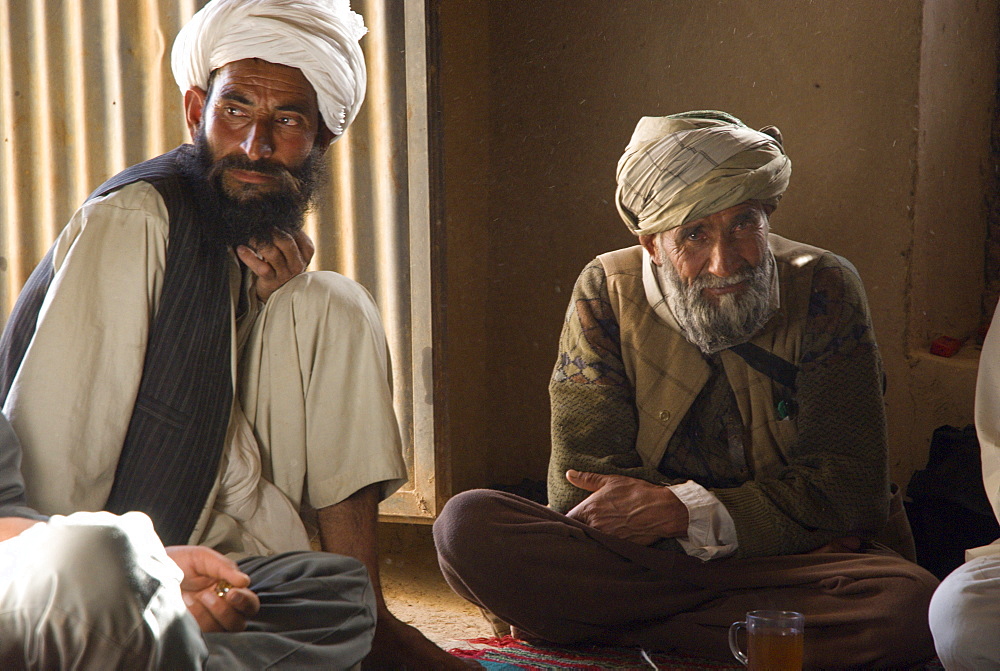 Villagers from Dera Jawal village, Jamal Addeen and Abdul Rahim, meet in the leader's guest room, Herat Province