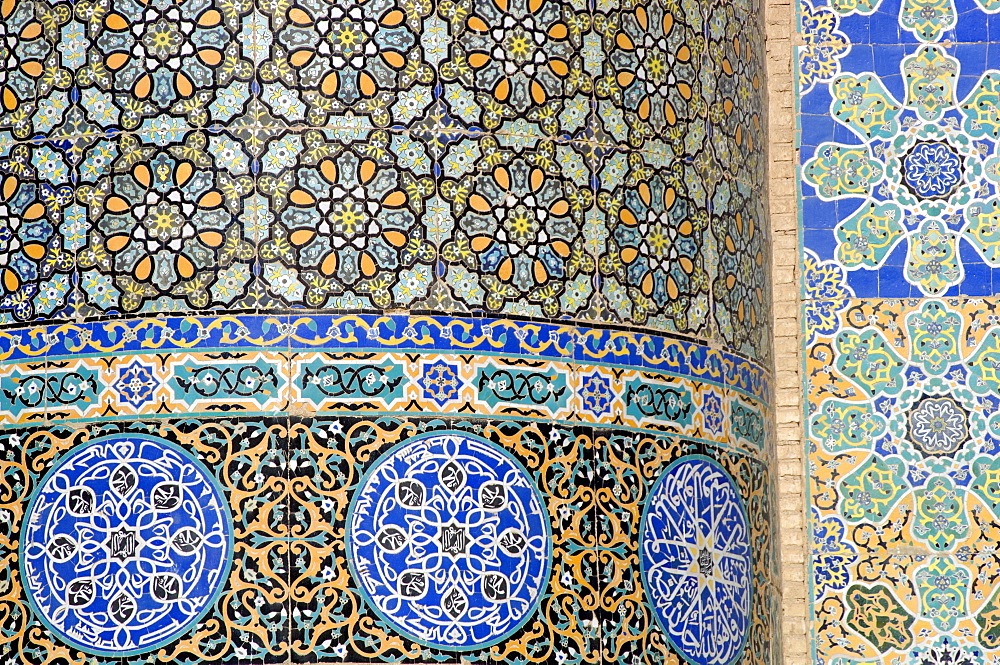 Floral & geometric patterns of  restored Timurid tile mosaics decorate a wall in the courtyard of the Friday Mosque or "Masjid-i Jami", the largest mosque in Herat, dating to 1200 AD, Herat, Afghanistan.  Much of the Ghorid and Timurid decorations on the mosque had been badly damaged during the centuries, but a restoration project begun in 1943 continues today.