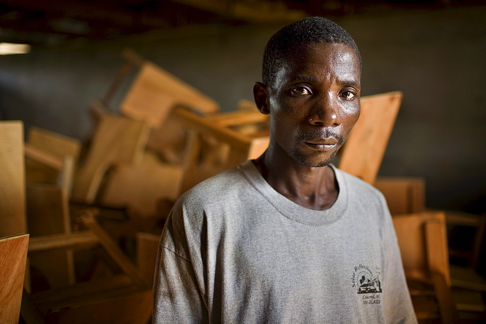 Portrait of a young Liberian man, Thomas Grant, in a carpentery workshop. After the long civil war employment opportunities remain few and capacity building a priority.