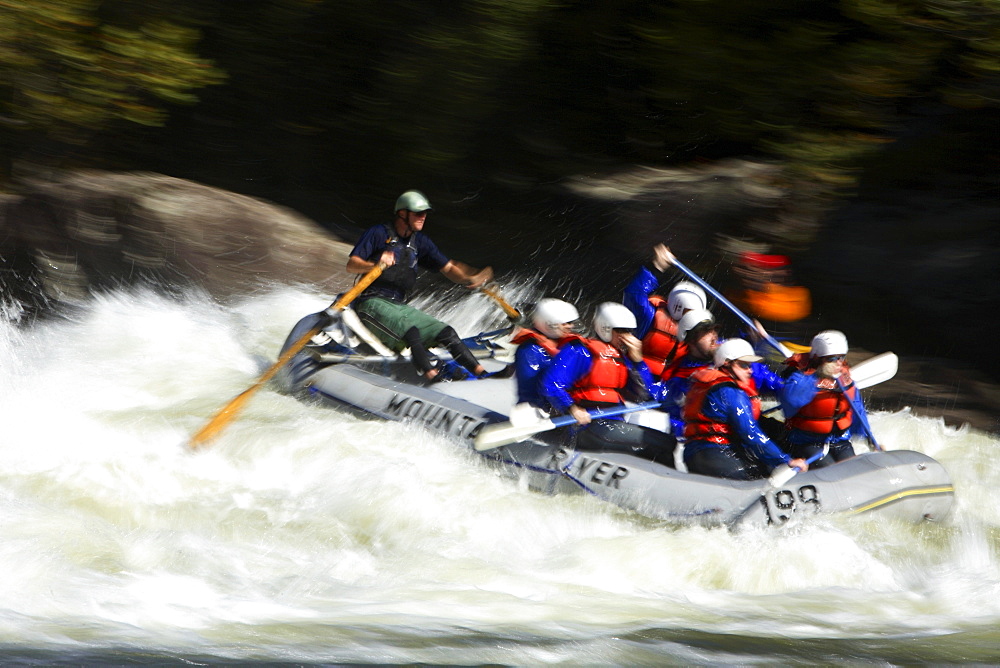 Motion-blur photo of unknown whitewater rafters crashing through Pillow Rock rapid on the Upper Gauley river near Fayetteville, WV