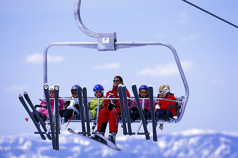 Heavenly Ski Instructor Danielle Ledesma riding the chairlift above Lake Tahoe with her class of young students at Heavenly Mountain Resort in South Lake Tahoe, California.