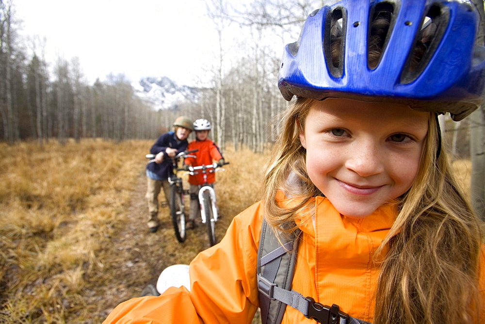 Portrait of young girl and boys mountain bike riding near Fallen Leaf Lake. Lake Tahoe, CA