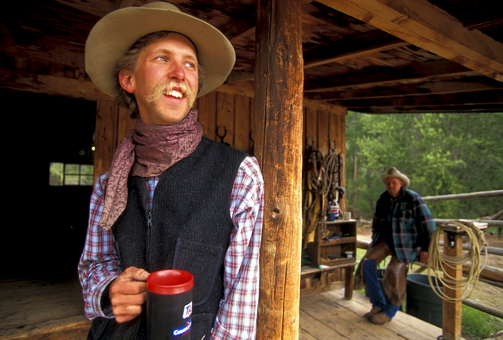 A cowboy employee of the CM guest ranch near Dubois, Wyoming, takes a coffee break.