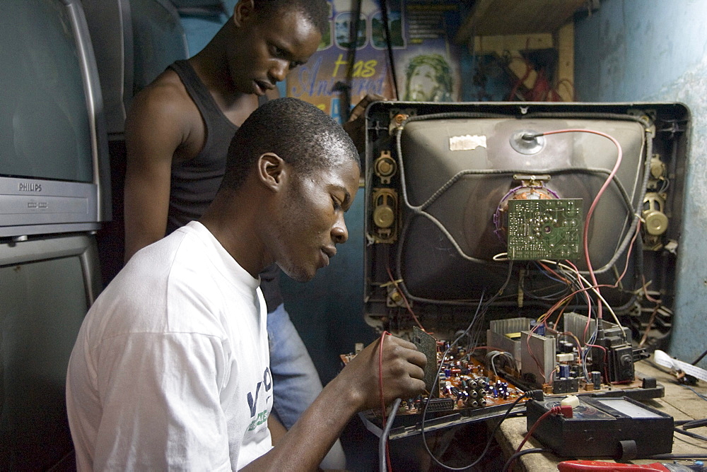 Alaba Market, Lagos Nigeria. Many of the computers here are second hand and shipped from Asia, the USA or Europe for reuse. The small shop dealers buy electronics from the containers and are very good at repairing the goods for sale. Only when material has no value is it sent to nearby dumps.