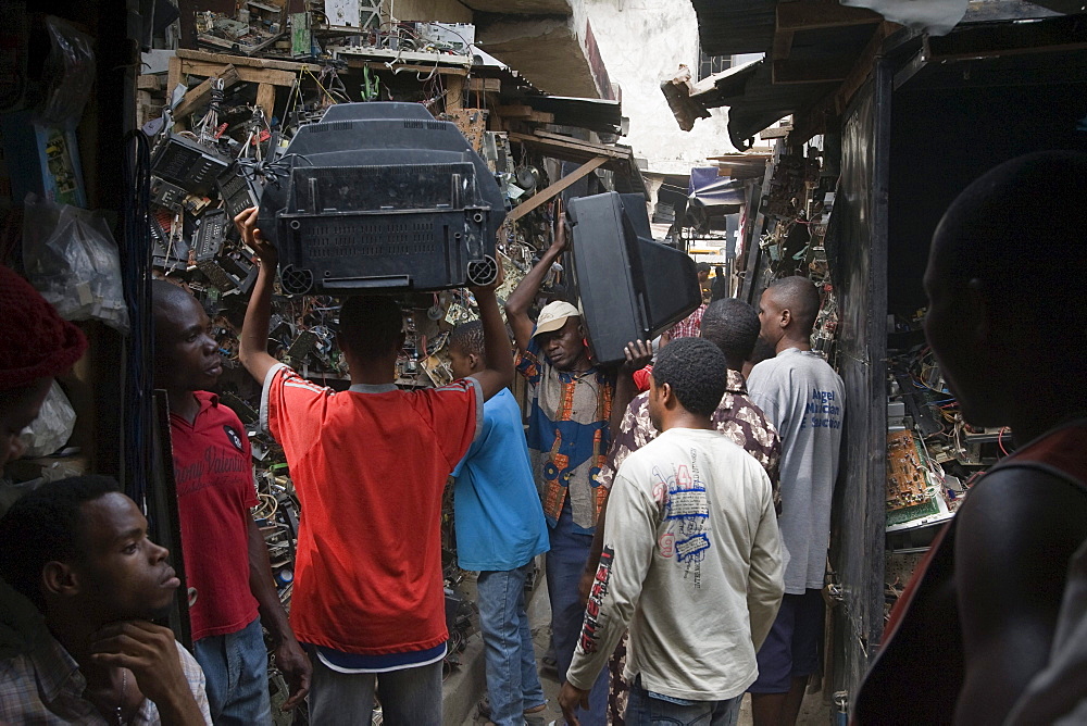 Alaba Market, Lagos Nigeria. Many of the computers here are second hand and shipped from Asia, the USA or Europe for reuse. The small shop dealers buy electronics from the containers and are very good at repairing the goods for sale. Only when material has no value is it sent to nearby dumps.