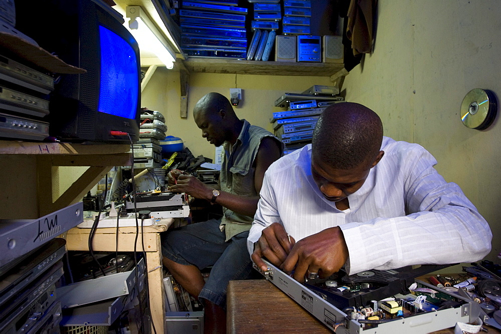 Alaba Market, Lagos Nigeria. Many of the computers here are second hand and shipped from Asia, the USA or Europe for reuse. The small shop dealers buy electronics from the containers and are very good at repairing the goods for sale. Only when material has no value is it sent to nearby dumps.