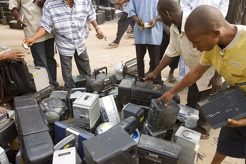 Alaba Market, Lagos Nigeria. Many of the computers here are second hand and shipped from Asia, the USA or Europe for reuse. The small shop dealers buy electronics from the containers and are very good at repairing the goods for sale. Only when material has no value is it sent to nearby dumps.