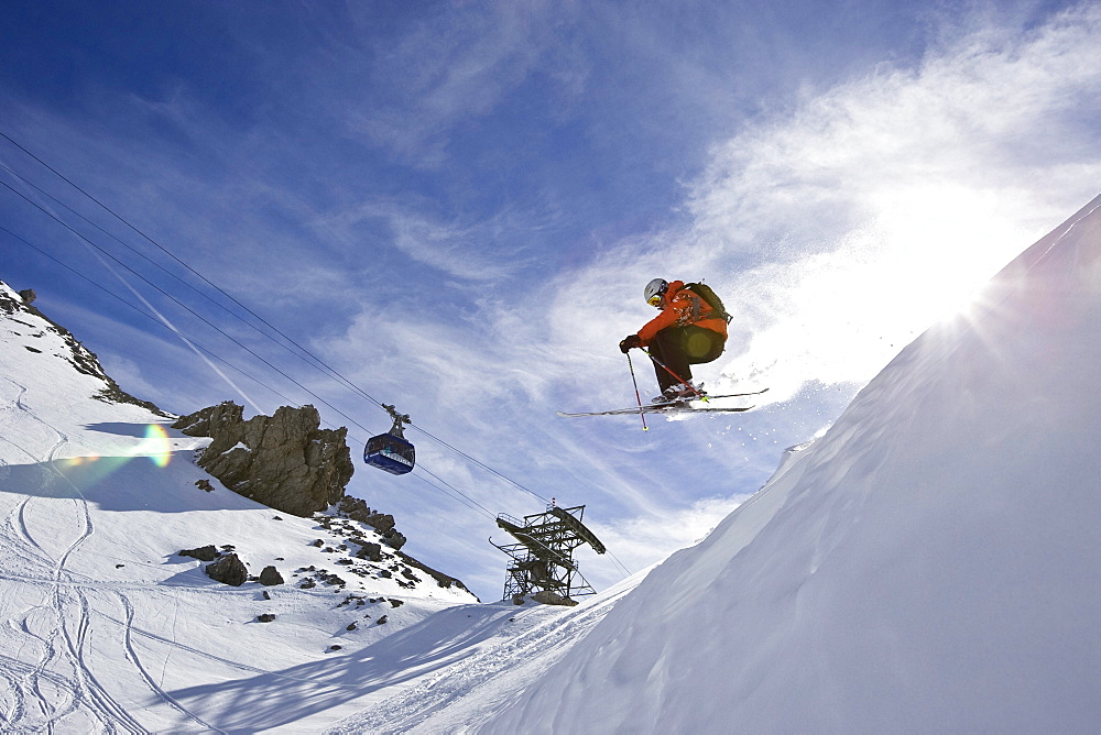 A man jumps off cornice while skiing in St. Anton am Arlberg, Austria.