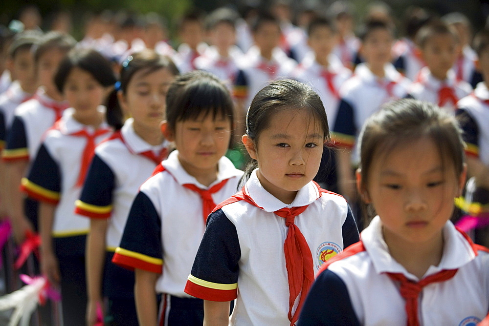 Chinese seven-year-old Shen Siyue stands surrounded by classmates as they line up for morning exercises at her elite school at in Beijing, China.