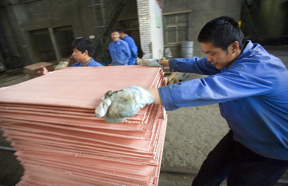 Chinese workers labor at a copper smelter in Tongling in China's central Anhui Province. The smelter refined some of the metals that will be used in the 2008 Summer Olympic medals to be held in Beijing.