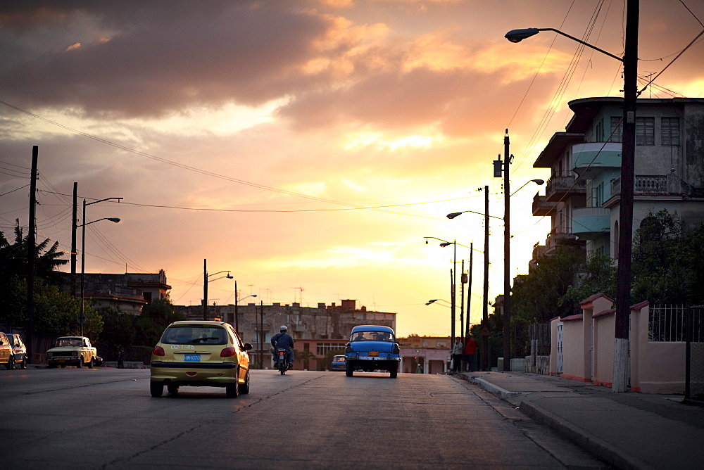 The sunsets over antique cars on the road in Havana, Cuba. The government of Cuba has now banned the export of such classic vehicles, as collectors from all over the world were buying the cars and moving them to other countries.