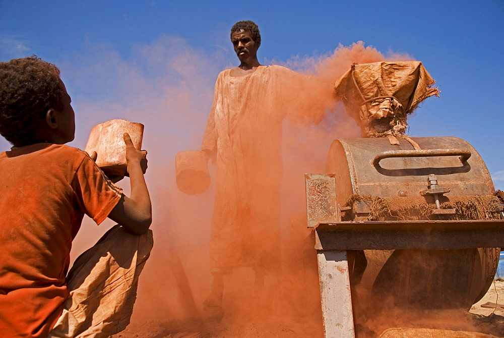 A boy helps crush stones in a special stone mill in Sudan. Illegal gold-mining in the region of the fourth cataract of the Nile in northern Sudan. People from the nearby villages work in shallow shafts in the desert. The rocks containing gold are crushed in a special mill. Some of the material is washed with water on the spot but the major part of it is taken to a village. 12/01/2007