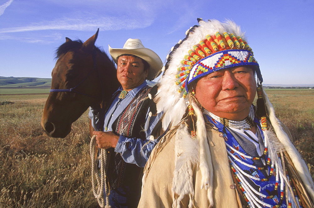 Chief of the Umatilla Tribes, Raymond Burke, Wish low tu latin, wears a traditional feather bonnet.