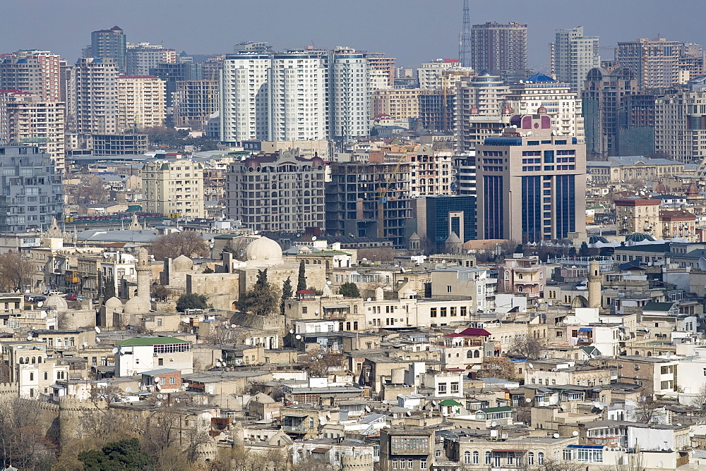 Baku, Azerbaijan - February 2008: Overview over the oil rich Azeri capital city of Baku.  The old city with its narrow streets and old mosques is contrasted by modern skyscrapers in the back.