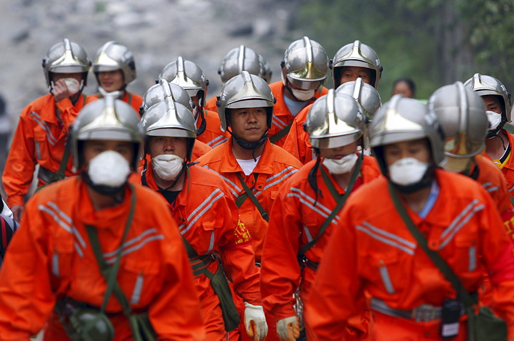 Chinese military descend upon Beichuan town to provide relief after Monday's earthquake. The Chinese government raised the death toll to 21,500 but has said fatalities could rise above 50,000. Tens of thousands could still be buried in collapsed buildings in Sichuan province, where the quake was centered.