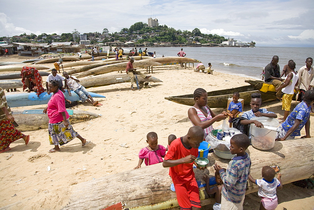 Monrovia, Liberia - September 19, 2007: Children selling snack food on the beach in the the fishing community of West Point in the Liberian capital of Monrovia which is one of the poorest slums in West Africa and suffers from overcrowding, lack of facilities, unemployment  and garbage. The fishing industry is an important source of employment and food for Liberians and is increasingly under threat by better equipped and unregulated foreign vessels over fishing in its unprotected waters.