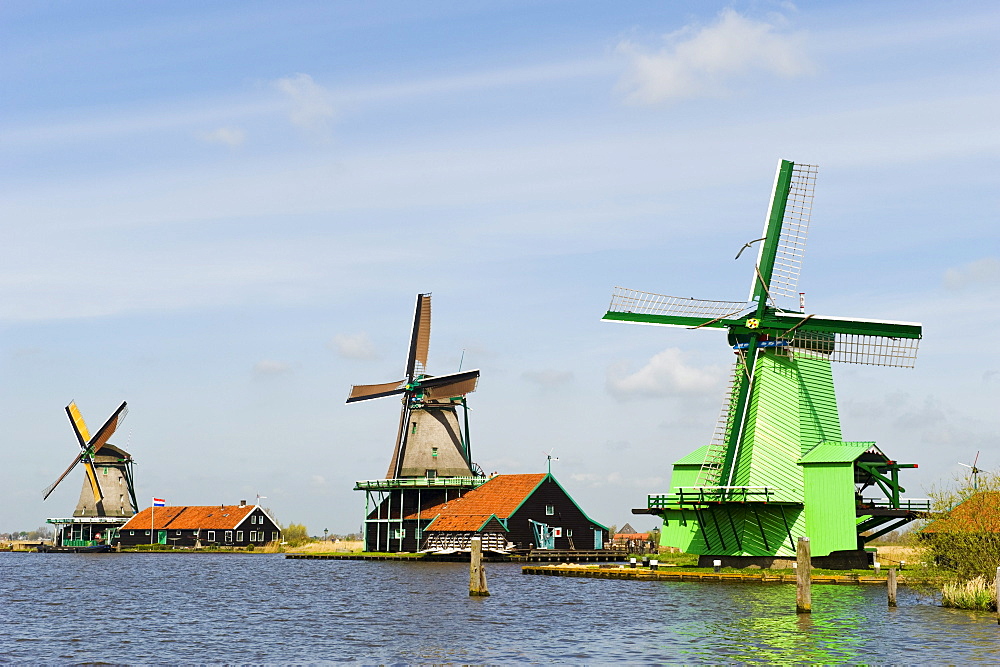 Windmills along a river in at Zaansche Schans, Holland, Netherlands.