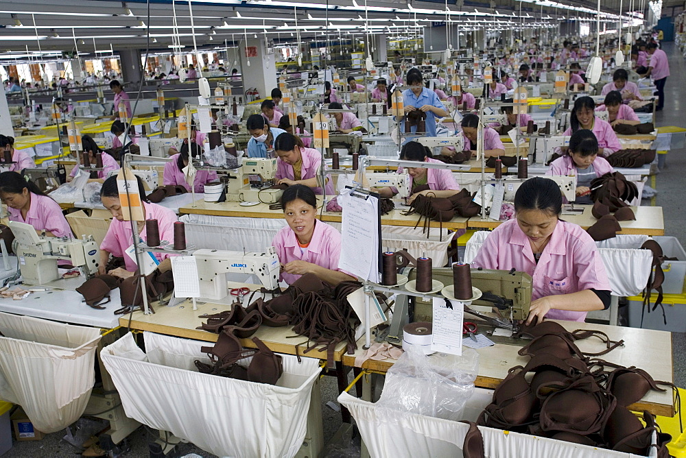 An overview of Chinese seamstresses at work, sewing bras in the Top Form factory in Longnan, China